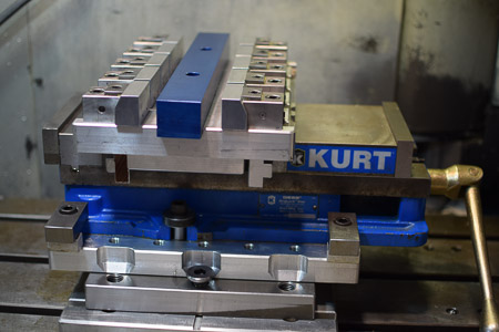 Old version of a multi vise set-up, in a Kurt Vise, on a base pallet, on a mounting plate