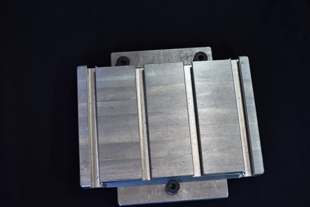A slotted, serrated pallet, mounted to a base pallet